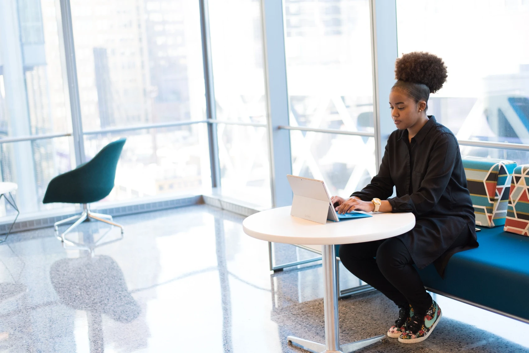 A woman connecting online at her laptop